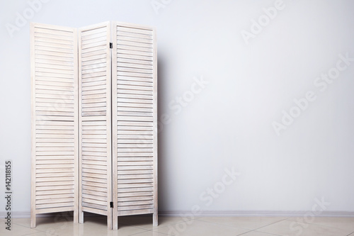 Fényképezés Wooden folding screen on a grey background