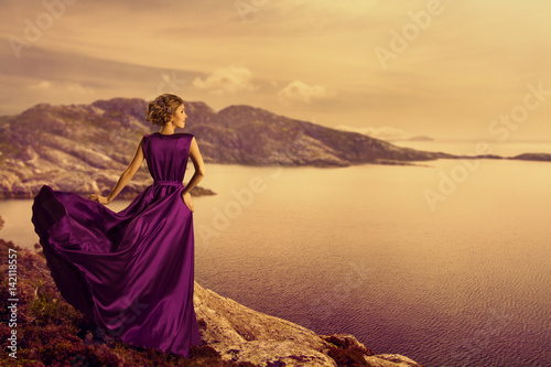 Woman in Elegant Dress on Mountain Coast, Fashion Model in Flowing Gown Cloth, Looking to Landscape View, Outdoor