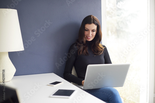 Thinking on new ideas. Shot of a young creative businesswoman working on laptop at office.