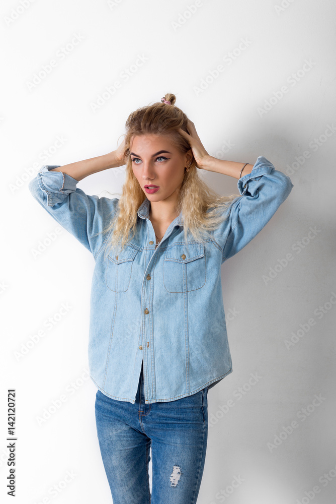 Blonde girl holding her hands on her head Blonde girl holding her hands on her head