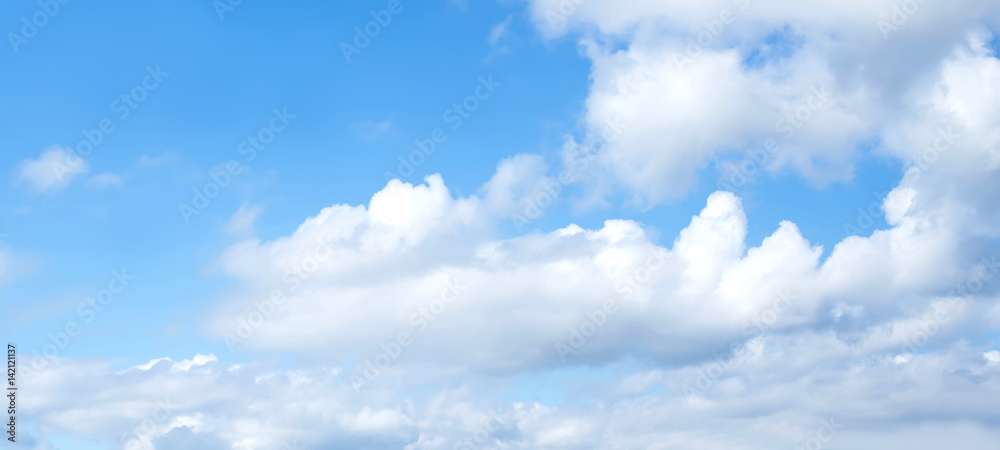 Sky background. Nature composition. Panoramic sunset sky background. Bright blue sky with lighted clouds. 