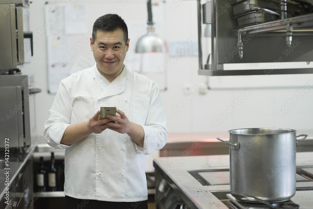 Chinese cook with smartphone Chinese cook with smartphone