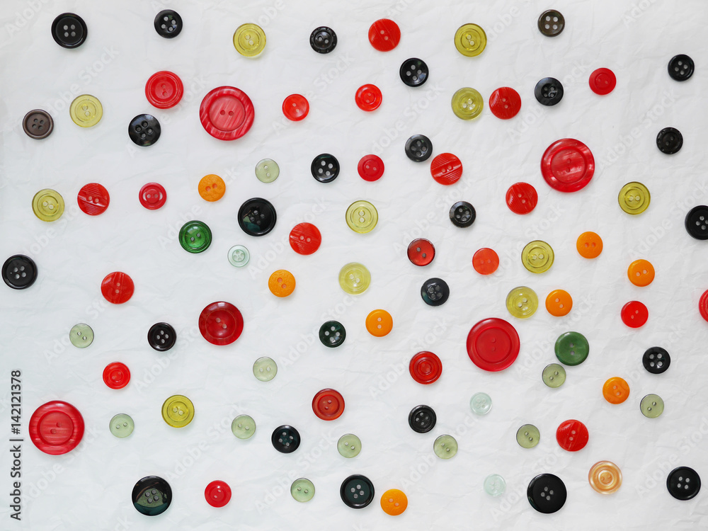 Background of multi-colored buttons. Abstract background. Pattern of buttons on a white background. Background of multi-colored buttons. Abstract background. Pattern of buttons on a white background.