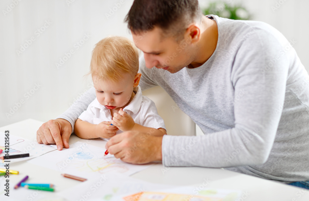 father and baby son paint together father and baby son paint together