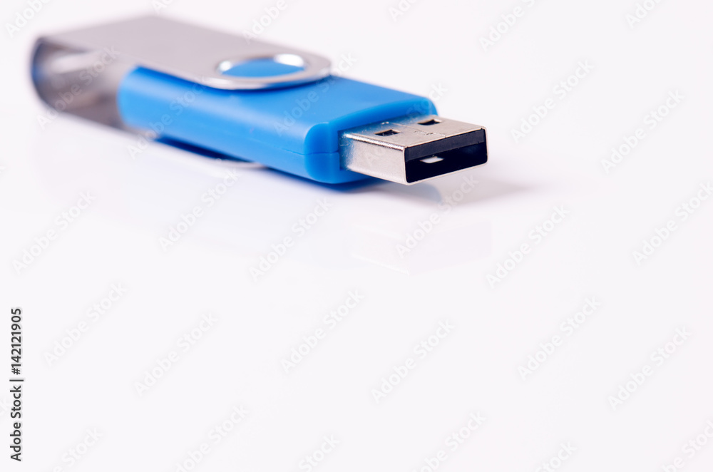 Detail of Usb flash drive on a white background. Flash drive is located in the corner of picture. Concept of technology. Isolated Detail of Usb flash drive on a white background. Flash drive is located in the corner of picture. Concept of technology. Isolated
