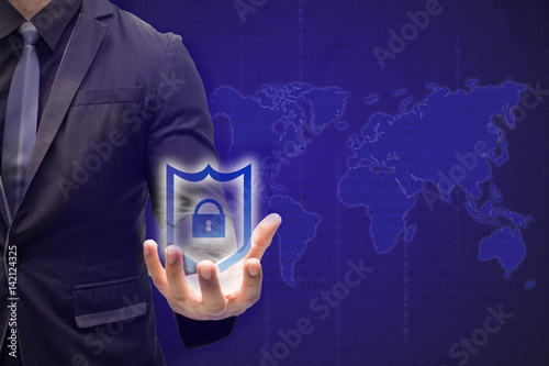 iot,internet of things,business and technology ,internet and networking concept-business man hold the shield to protect and secure the data or information the shield will reject the data which harmful