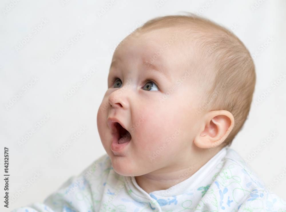 Boy smiling open mouth with no teeth, on a light background. Boy smiling open mouth with no teeth, on a light background.