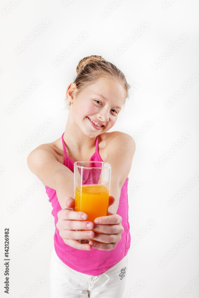 Child girl holding a glass of orange juice. The concept of healthy food and vitamins. Child girl holding a glass of orange juice. The concept of healthy food and vitamins.