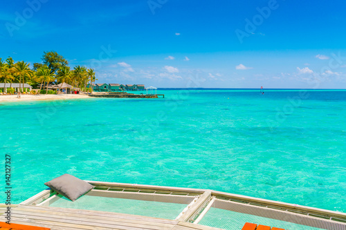 Vacation net seat in tropical Maldives island and beauty of the sea with the coral reefs . © jannoon028