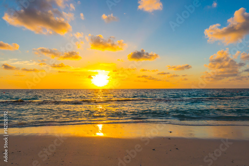 Beautiful sunset with sky over calm sea  in tropical Maldives island