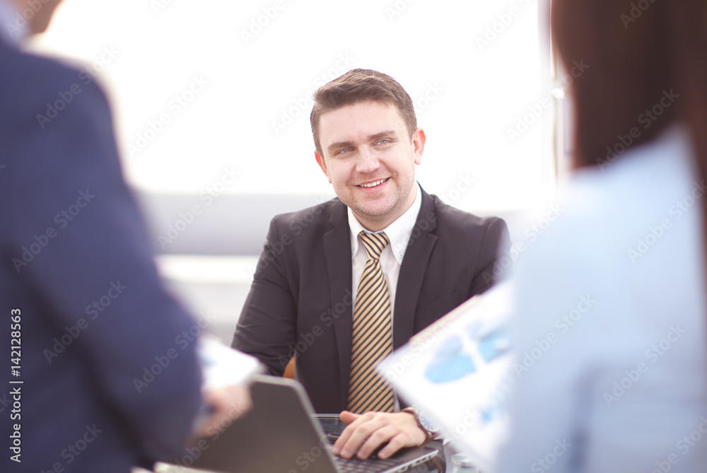 Happy smart business man with team mates discussing Happy smart business man with team mates discussing