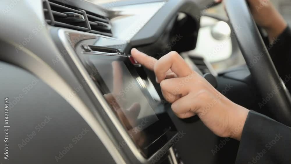 Close up shot hand of woman using touch screen in car shallow depth of field Close up shot hand of woman using touch screen in car shallow depth of field