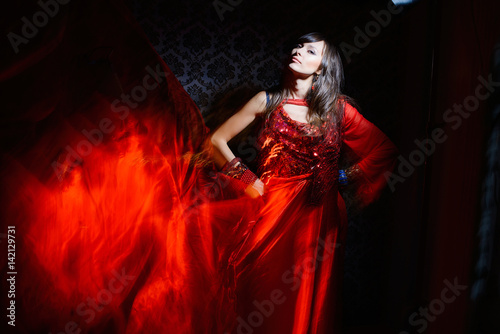 woman in red waving dress in interior © lanarusfoto
