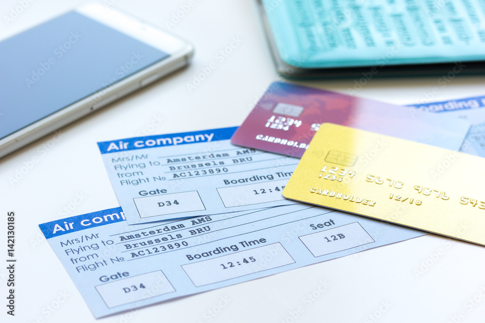 travel concept with credit cards and flight tickets on wooden table travel concept with credit cards and flight tickets on wooden table