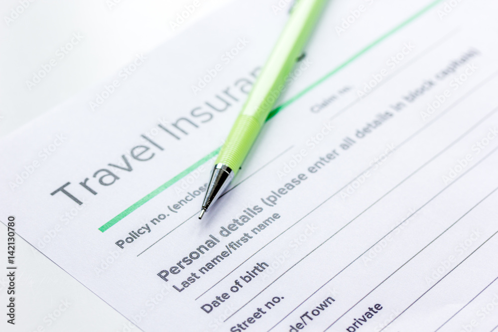 Traveling concept with insurance application on white table