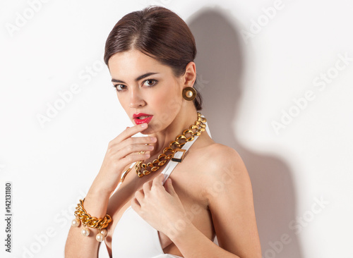 Beautiful woman with golden jewelry