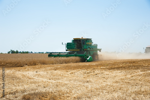 Combine harvesters in a field of wheat