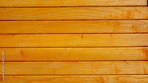 Orange wooden fence with ash tree. The texture of wood background