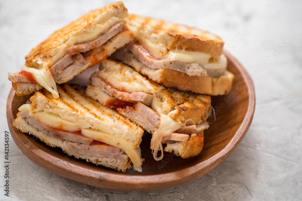 A grilled ham and swiss cheese sandwich A grilled ham and swiss cheese sandwich