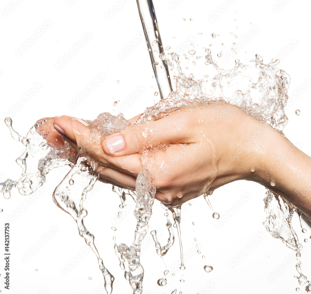 Closeup female hands under the stream of splashing water Closeup female hands under the stream of splashing water
