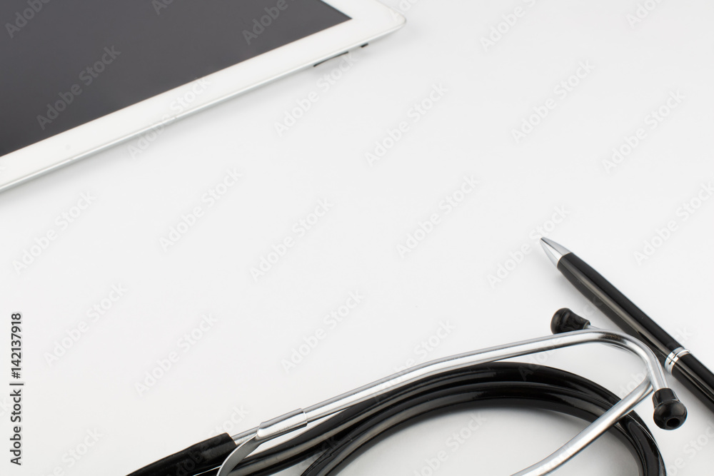 Tablet computer, metal silver-black pen and stethoscope on a white background Tablet computer, metal silver-black pen and stethoscope on a white background