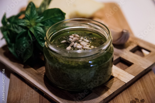 Fresh pesto with basil in glass jar. photo