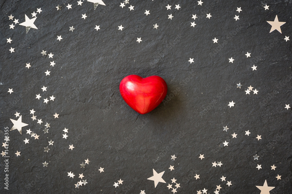 Small red heart on the black background with silver stars. Hearts and ...