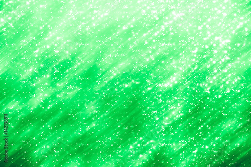 Green abstract background. Bokeh or round defocused particles or glitter lights