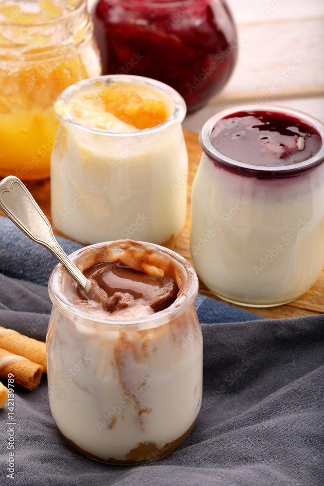 Fresh creamy dessert in a jar on wooden background Fresh creamy dessert in a jar on wooden background