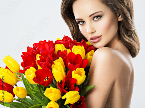 Sexy young woman with flowers.
