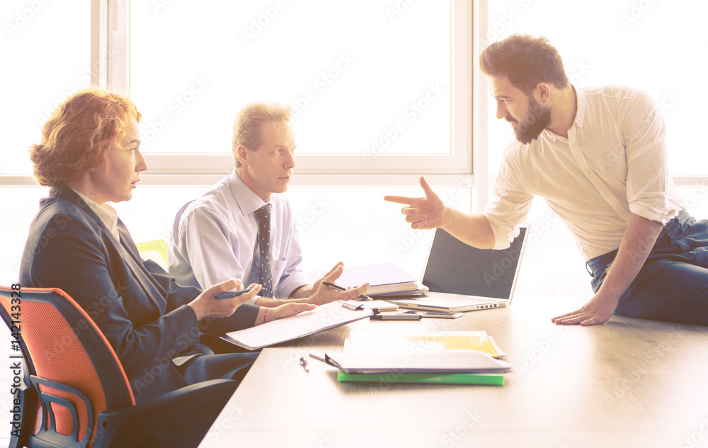 Obraz premium Toned of man explaining employees about his previous companies he worked in. Handsome man offering his CV for investigation of his experience.