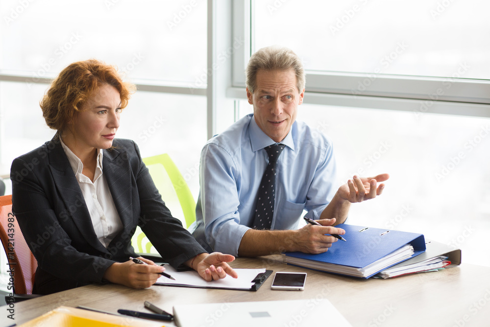 Difficult job interview in board room in office. Business representatives of company asking difficult questions while having interview. Difficult job interview in board room in office. Business representatives of company asking difficult questions while having interview.