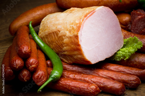 Sausages and meat delicacies with green pepper.