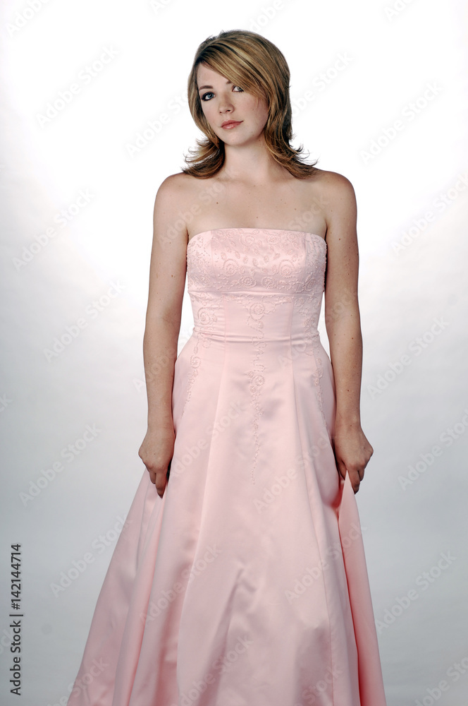 Young Beautiful Woman in Formal Pink Gown Young Beautiful Woman in Formal Pink Gown