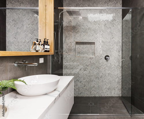 Marble mosaic herringbone tiled shower feature in a contemporary ensuite bathroom