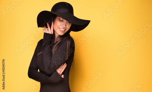 Fashionable young asian girl in hat.