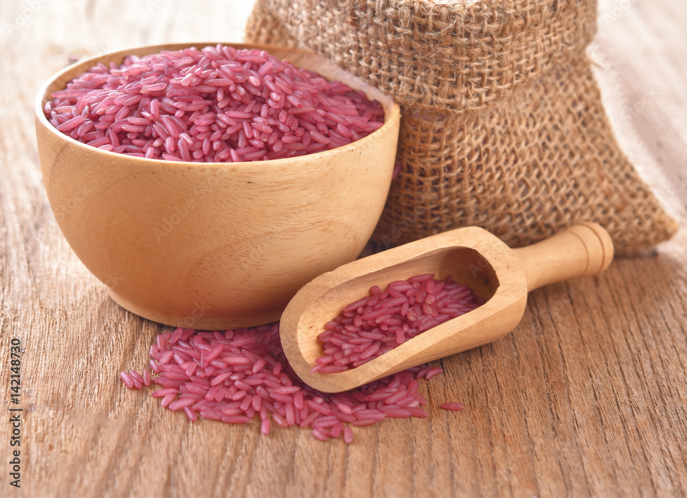 Brown rice in a wooden bowl on a table