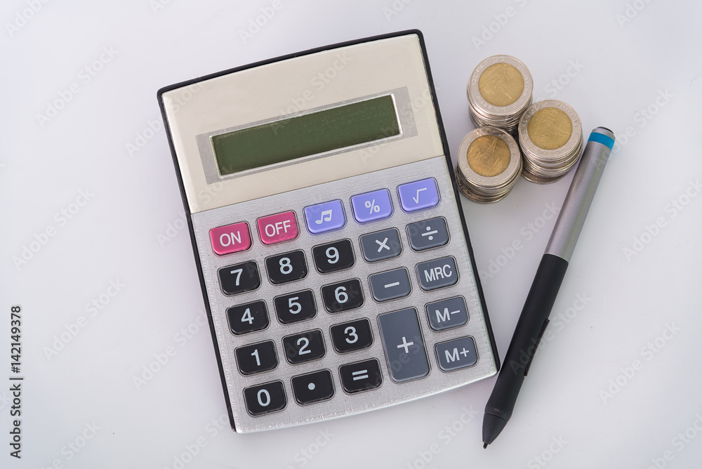 Increasing columns of coins, piles of coins arranged as a graph and calculator with pen on white background Increasing columns of coins, piles of coins arranged as a graph and calculator with pen on white background