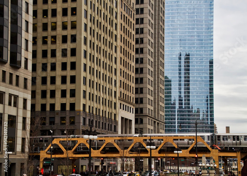 Transit system in Chicago - The Elevated "el" train crosses Wacker Drive on the Wells Street bridge during evening commute. © shellybychowskishots
