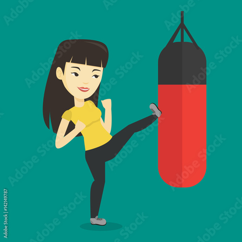 Woman exercising with punching bag.