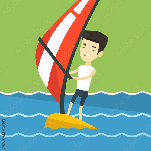 Young man windsurfing in the sea.