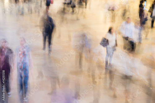 Fast moving crowd of commuters at Grand Central Station in New York. Motion blur of figures headed to their jobs. Working life in the city.