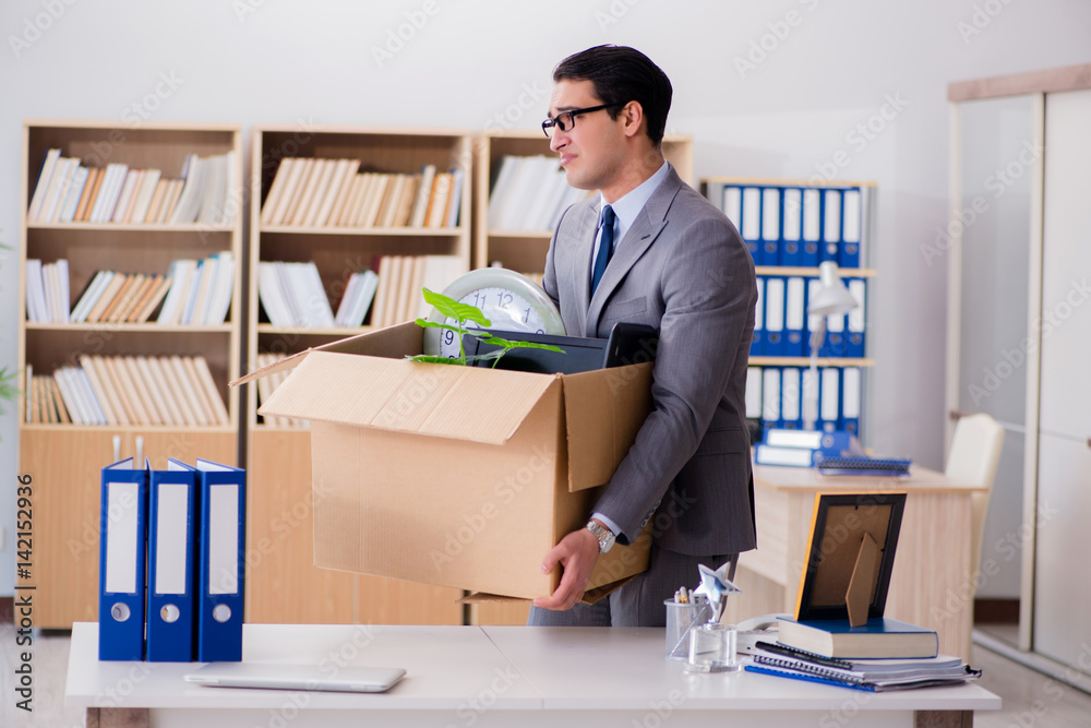 Man moving office with box and his belongings Man moving office with box and his belongings