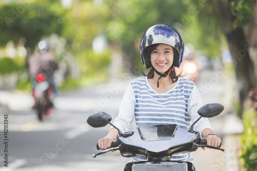 woman riding a motorcyle or motorbike