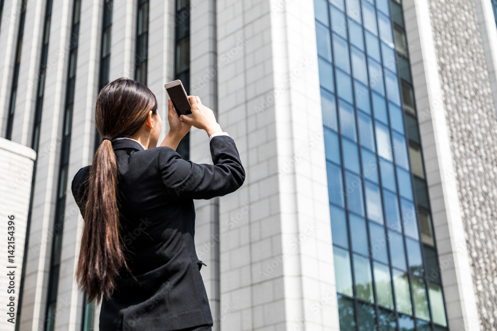 business woman taking a photo with smart phone business woman taking a photo with smart phone
