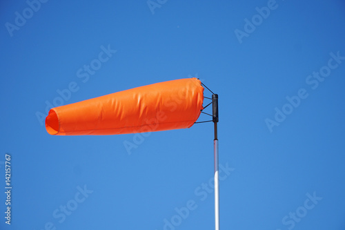close up on orange windsock in the wind photo