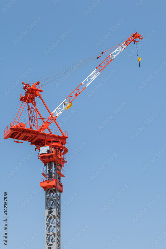 Close - up big red crane at construction site Close - up big red crane at construction site