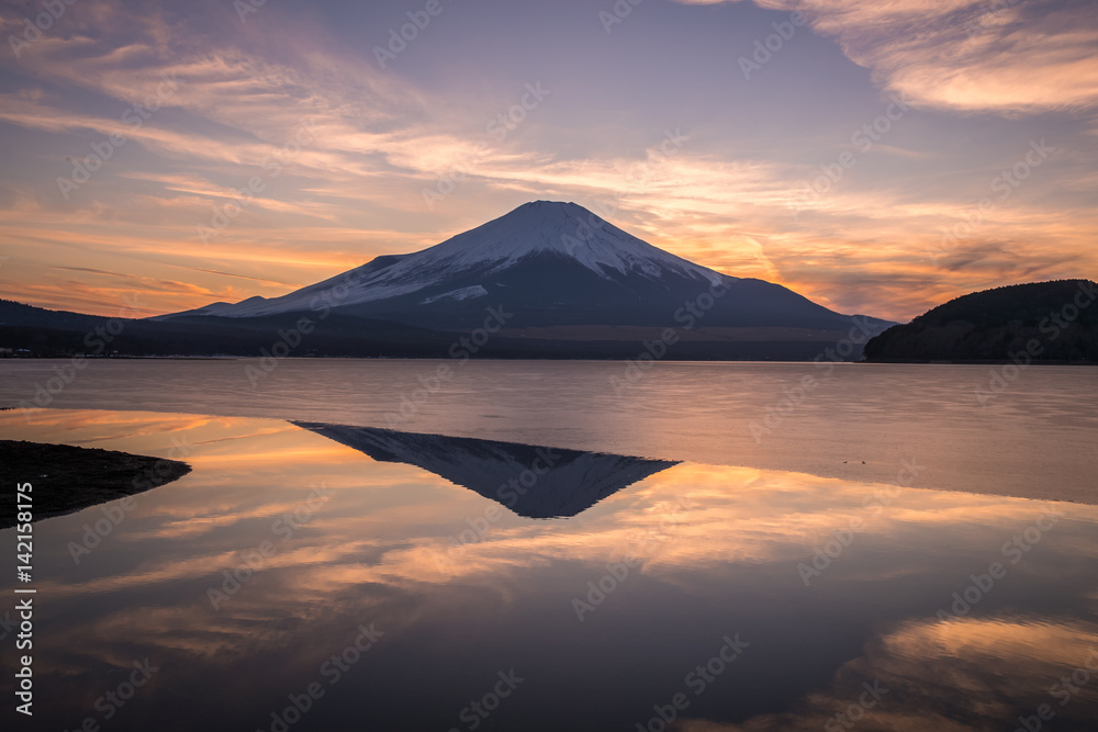 Mountain Fuji and Yamanakako ice lake with reflection in evening winter Mountain Fuji and Yamanakako ice lake with reflection in evening winter