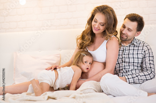  pregnant wife and husband with a child
