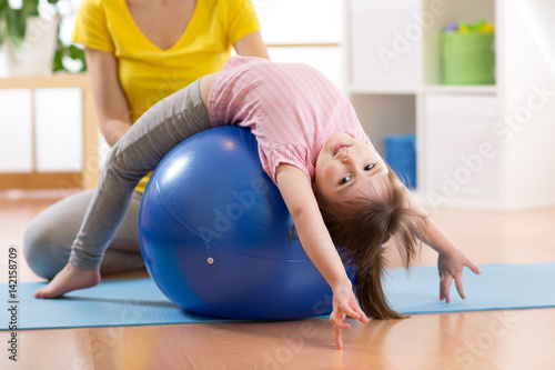 Cute child girl stretching ...